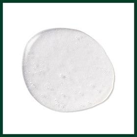 Aveda Control Force can beside a hand to show 9.1-ounce size and scale