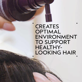 Aveda Invati Ultra dropper applying serum to scalp demonstrating targeted use