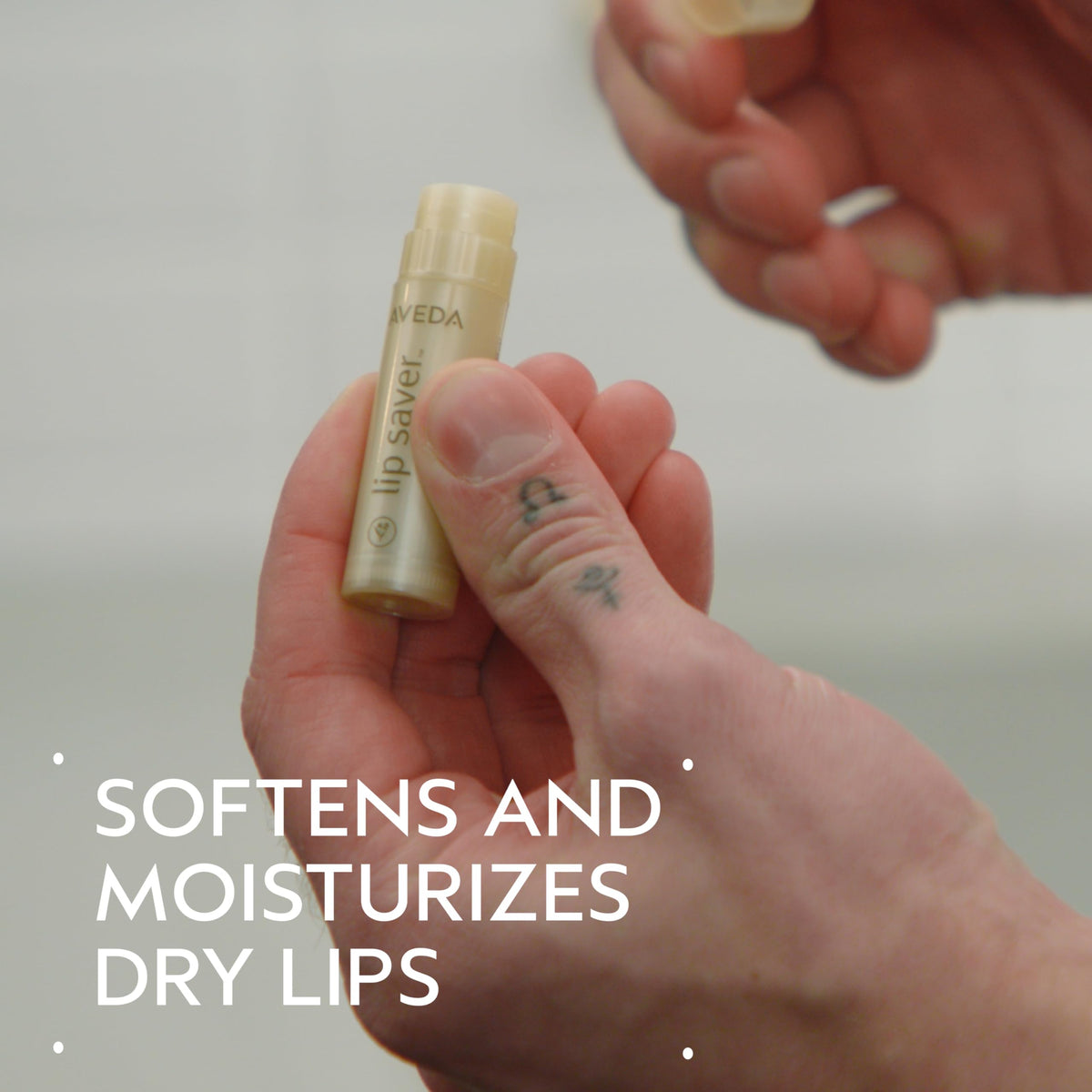 Aveda lip saver cap removed close-up revealing balm tip, precise application benefit