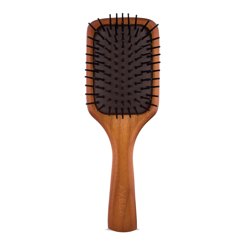 Aveda mini paddle brush front view showing compact shape and smoothing benefit
