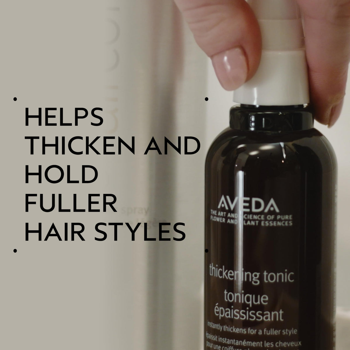 Aveda Thickening Tonic spraying fine mist demonstrating even application and fuller hair
