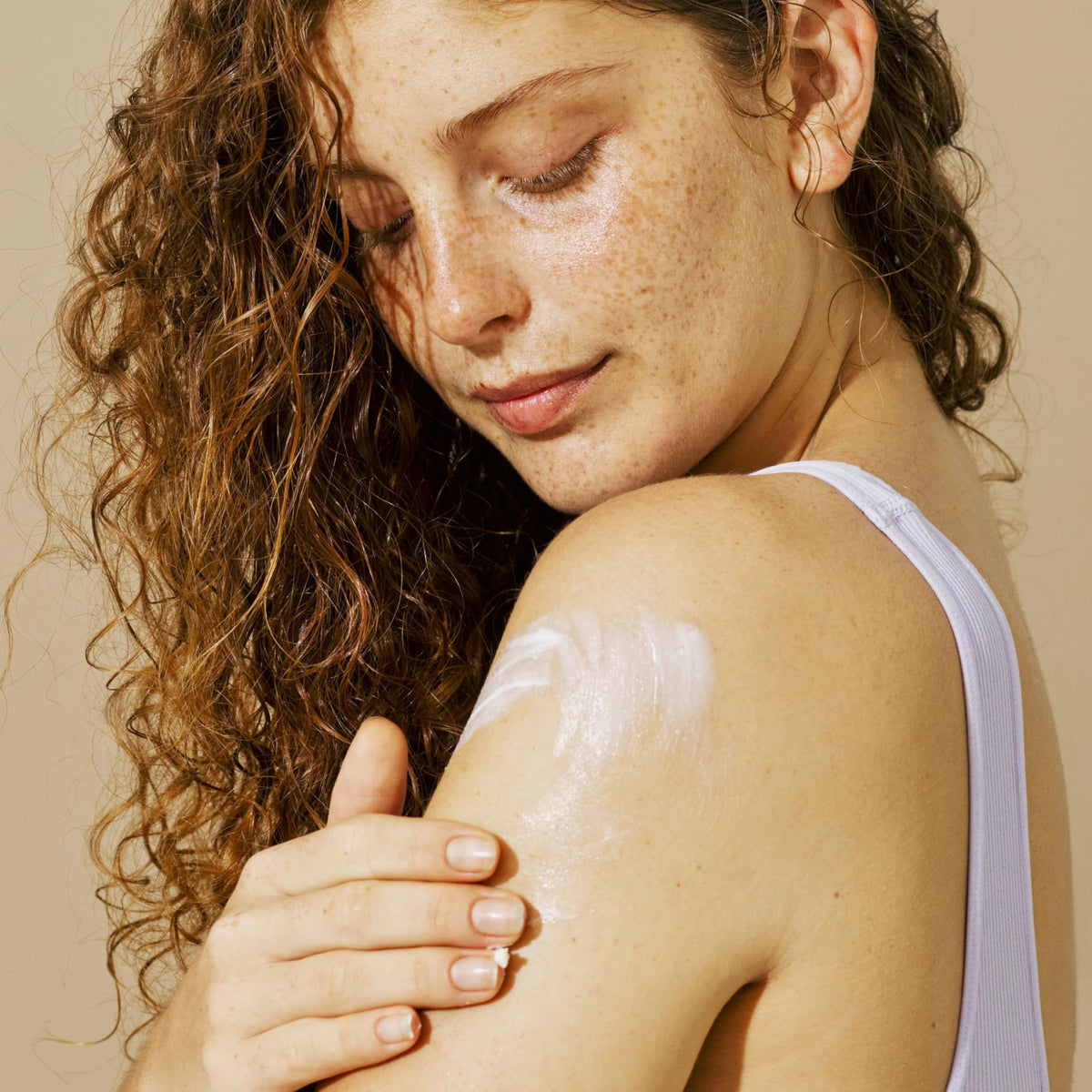Aveeno being applied to forearm showing softened, moisturized skin