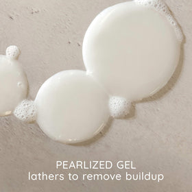 Aveeno shampoo texture on palm demonstrating gentle, creamy lather