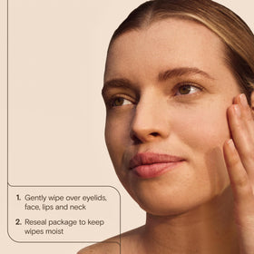 Aveeno wipe next to hand to show size and single-use convenience