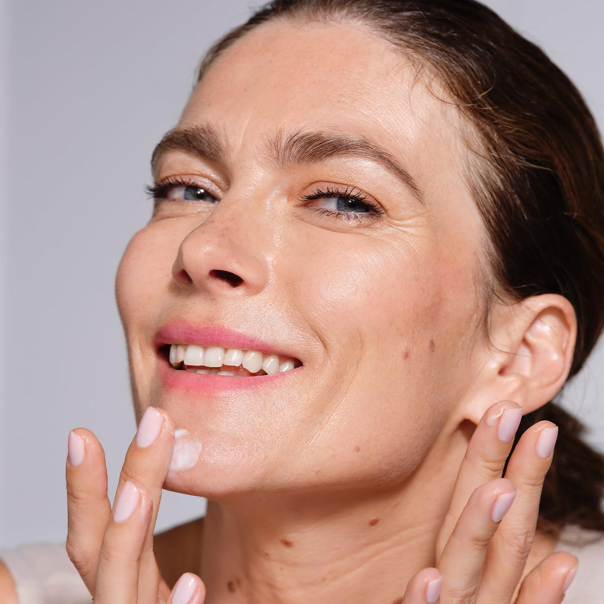 AVON Anew day cream on bathroom shelf lifestyle shot suggesting morning routine ease