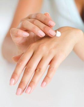 AVON tube being applied to dry hands to demonstrate soothing repair action