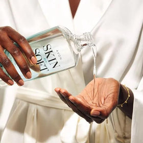 AVON applying body oil to damp skin, illustrates quick absorption and softness