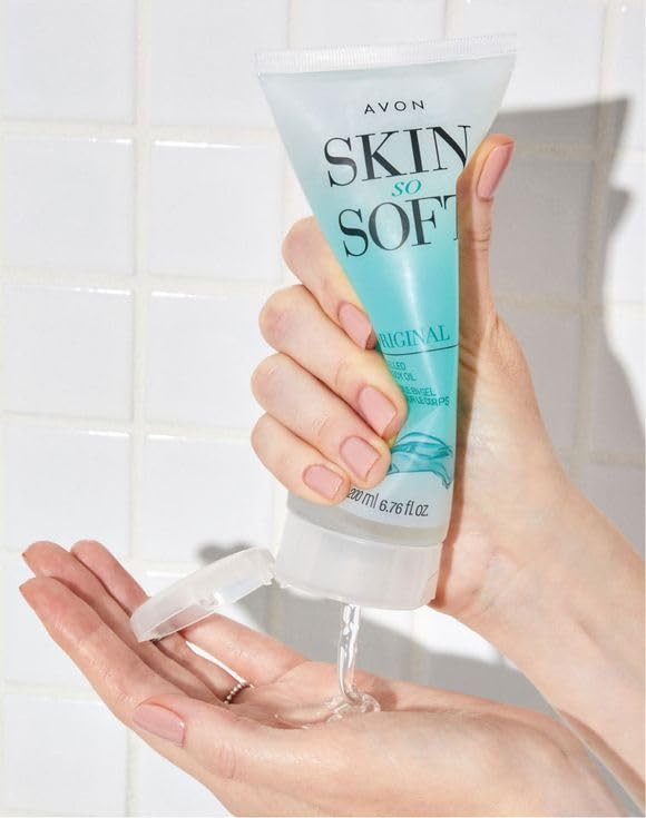 AVON Skin So Soft tube beside measuring tape and hand, showing 6.76 fl oz scale and portability