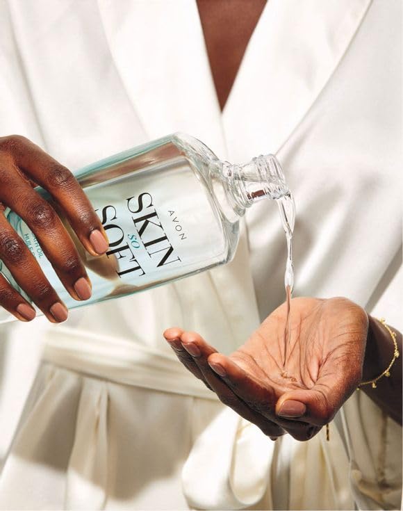 AVON bottle next to hand for size comparison showing generous 16.9 fl oz
