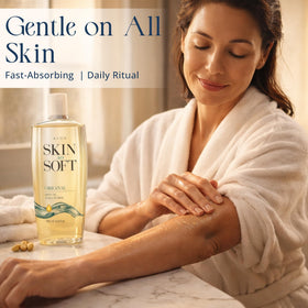 AVON Skin So Soft bottle next to hand showing 16.9 fl oz size and scale