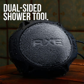 AXE scrubber next to bottle of body wash demonstrating compatibility and product efficiency