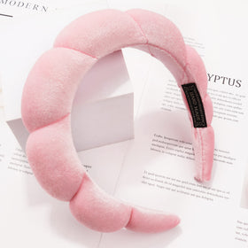 Ayesha headband worn while washing face showing secure non slip benefit