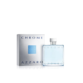 Azzaro Chrome lifestyle beach setting with bottle on sand conveying summer vibe benefit: coastal energy