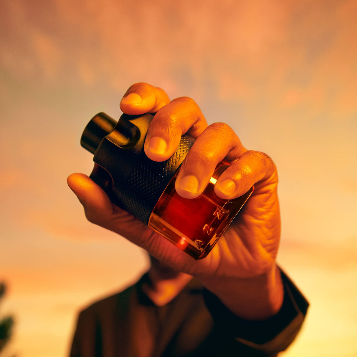 Azzaro bottle in hand to show travel-size convenience and portability benefit