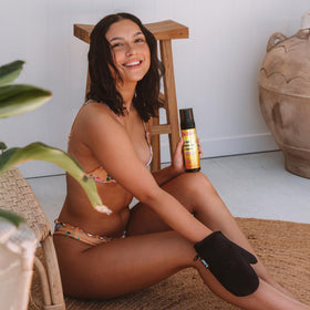 b.tan lifestyle shot at beach showing sunless tan confidence benefit