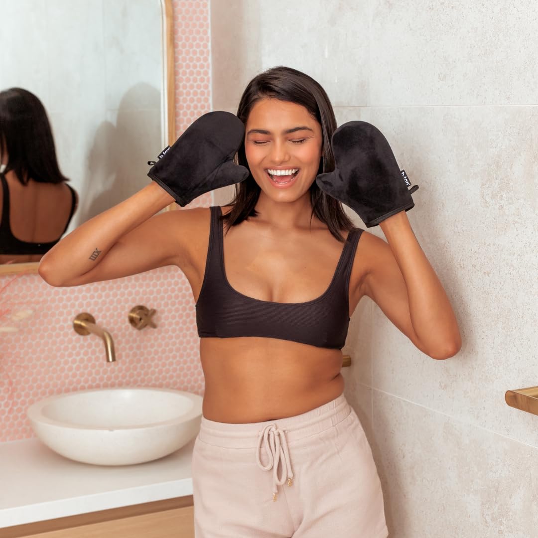 B.TAN mitt being rinsed under water showing washable, reusable convenience