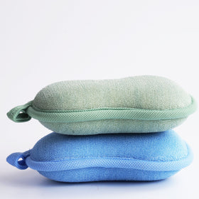 BabaMate sponge held in adult hand to show compact size handling benefit