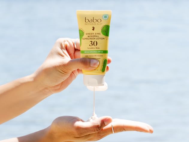 Babo Botanicals travel-size tube in a beach bag for convenient on-the-go use