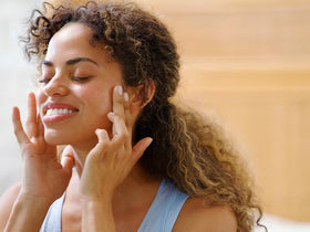Babo Botanicals parent applying cream to baby, gentle calming benefit