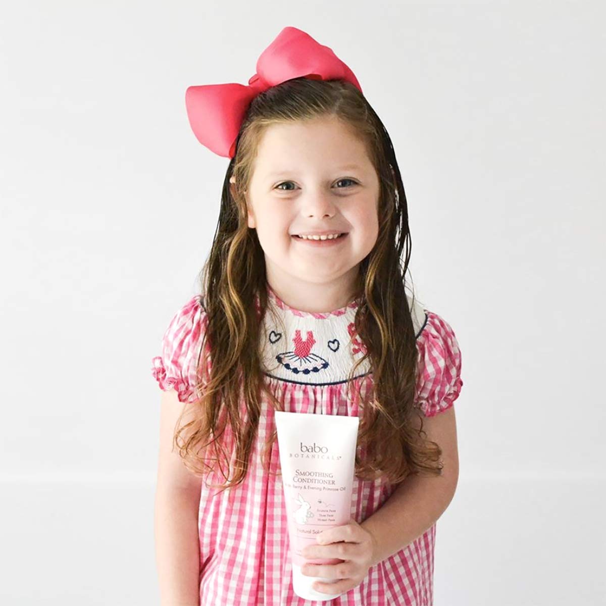 Babo Botanicals lifestyle image of parent and baby haircare showing gentle smoothing