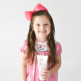 Babo Botanicals lifestyle image of parent and baby haircare showing gentle smoothing