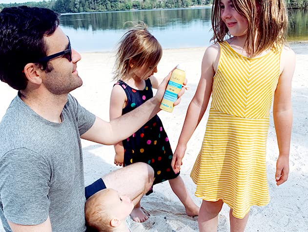 Babo Botanicals bottle in hand to show 6-ounce size and portability