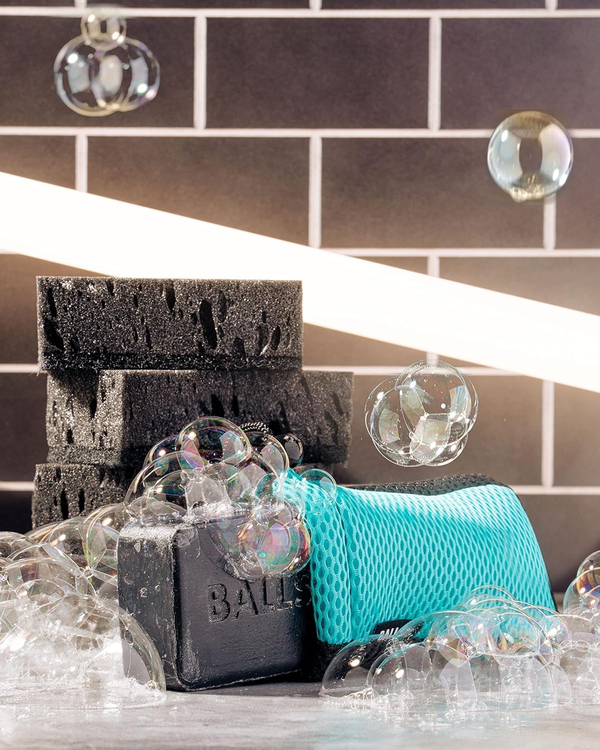 Ballsy Sud Sack held in hand under running shower for easier soap handling benefit