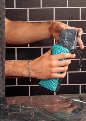 Ballsy Sud Sack beside bar soap to show size compatibility and convenience benefit