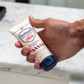 Hand holding Barbasol 1919 3 oz bottle for scale, demonstrating TSA-friendly travel size