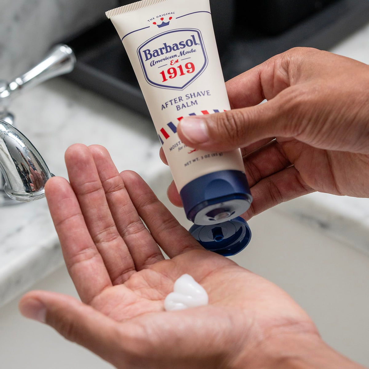 Close-up of Barbasol 1919 balm texture on fingertips, highlighting quick-absorbing moisturizing feel