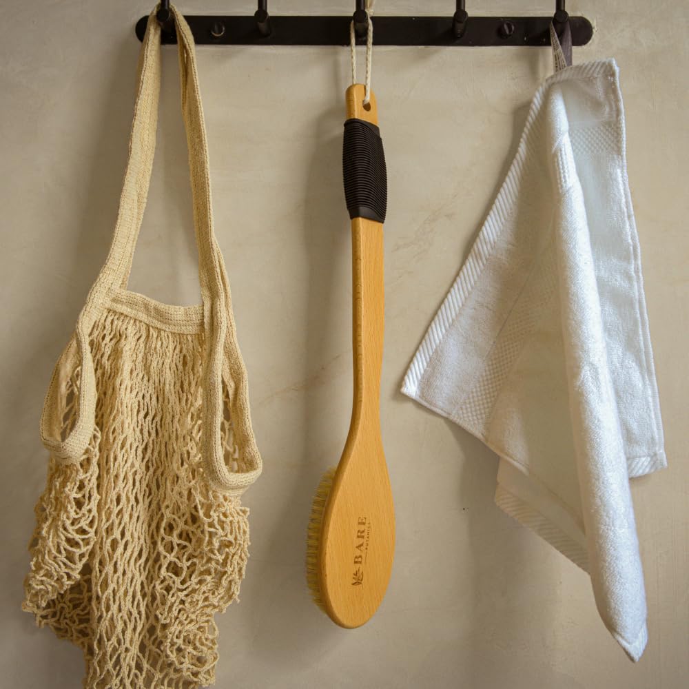 Bare Botanics in-shower use with water showing wet exfoliation and stable handling benefit