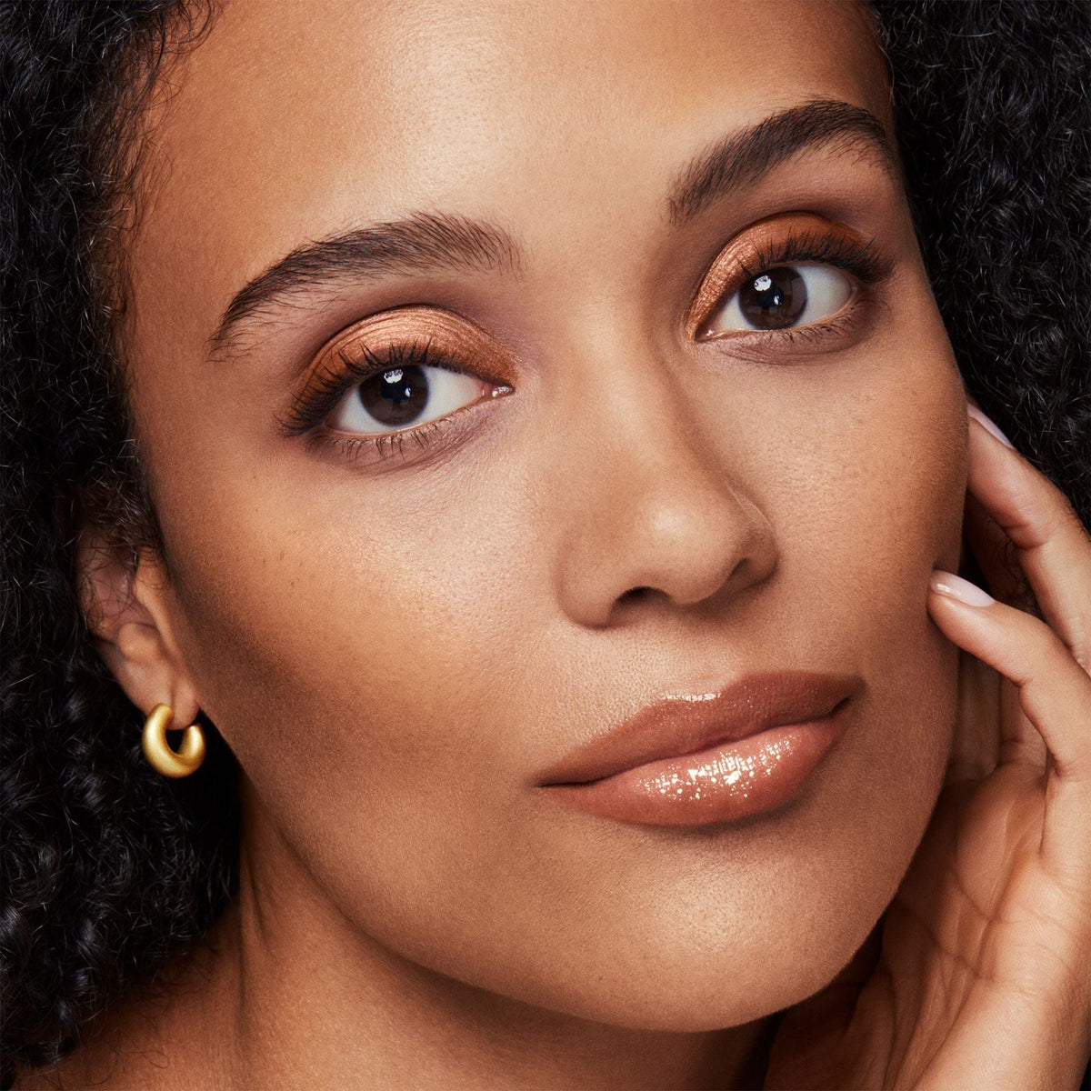 bareMinerals powder on brush being applied to cheek for natural warm contour and easy blending