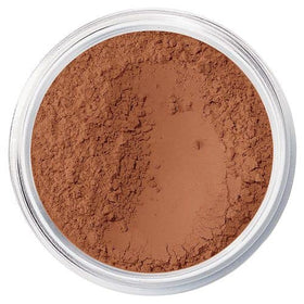 bareMinerals compact jar held in hand to show size and travel-friendly convenient packaging