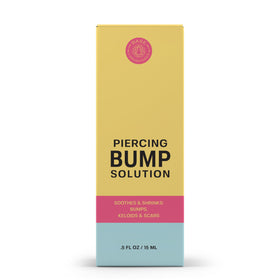 BASE LABORATORIES applying oil to ear piercing to soothe and soften