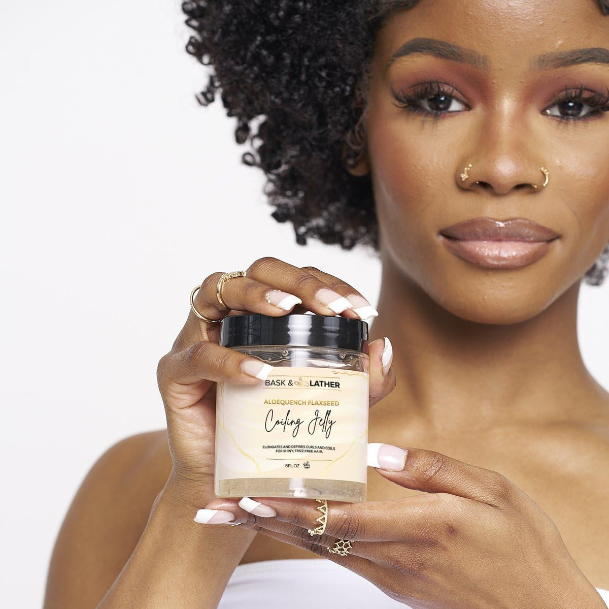 BASK & LATHER applied to wet curls demonstrating hydration and defined coil shaping