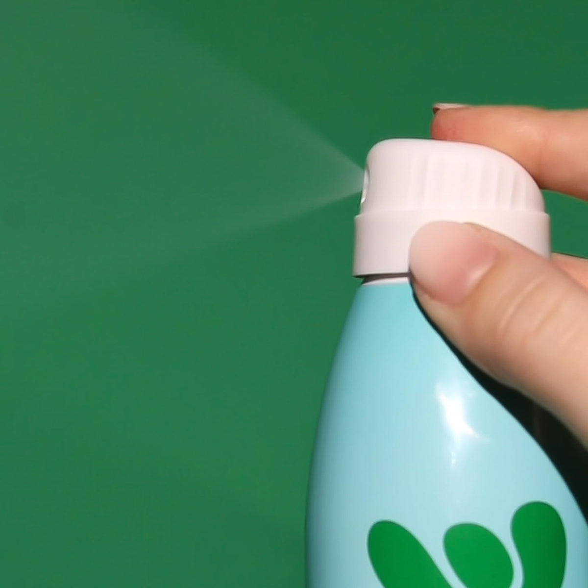Bask size comparison in hand showing compact 5.5 oz bottle for travel convenience