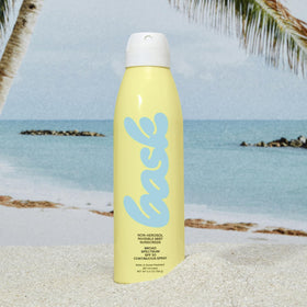 Bask bottle in hand for scale highlighting travel-friendly 5.5 oz size