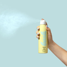 Bask travel sized bottle in beach bag showing portable reef‑friendly protection