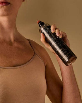 Bath & Body Works bottle in evening outfit setting suggesting refined, ready-for-night scent