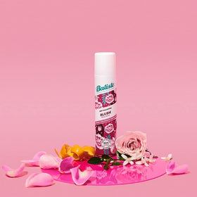 Batiste can held in hand showing travel-friendly 6.73 ounce scale