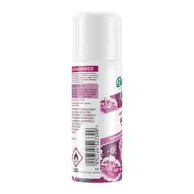 Three 1.6oz Batiste cans beside passport and toiletries, travel-friendly