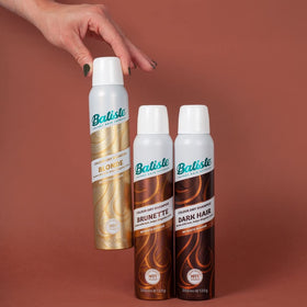Batiste lifestyle scene of woman refreshing hair for instant confidence