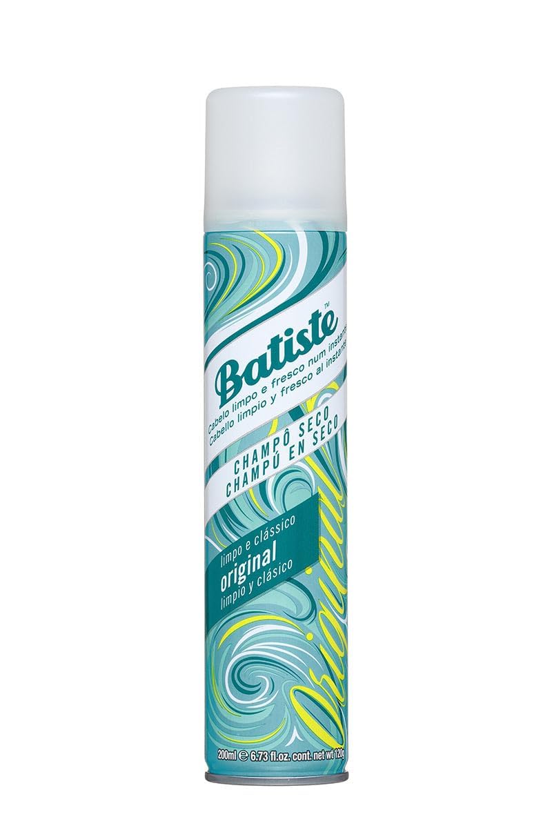 Batiste in-use spray being applied at roots to absorb oil and add instant volume