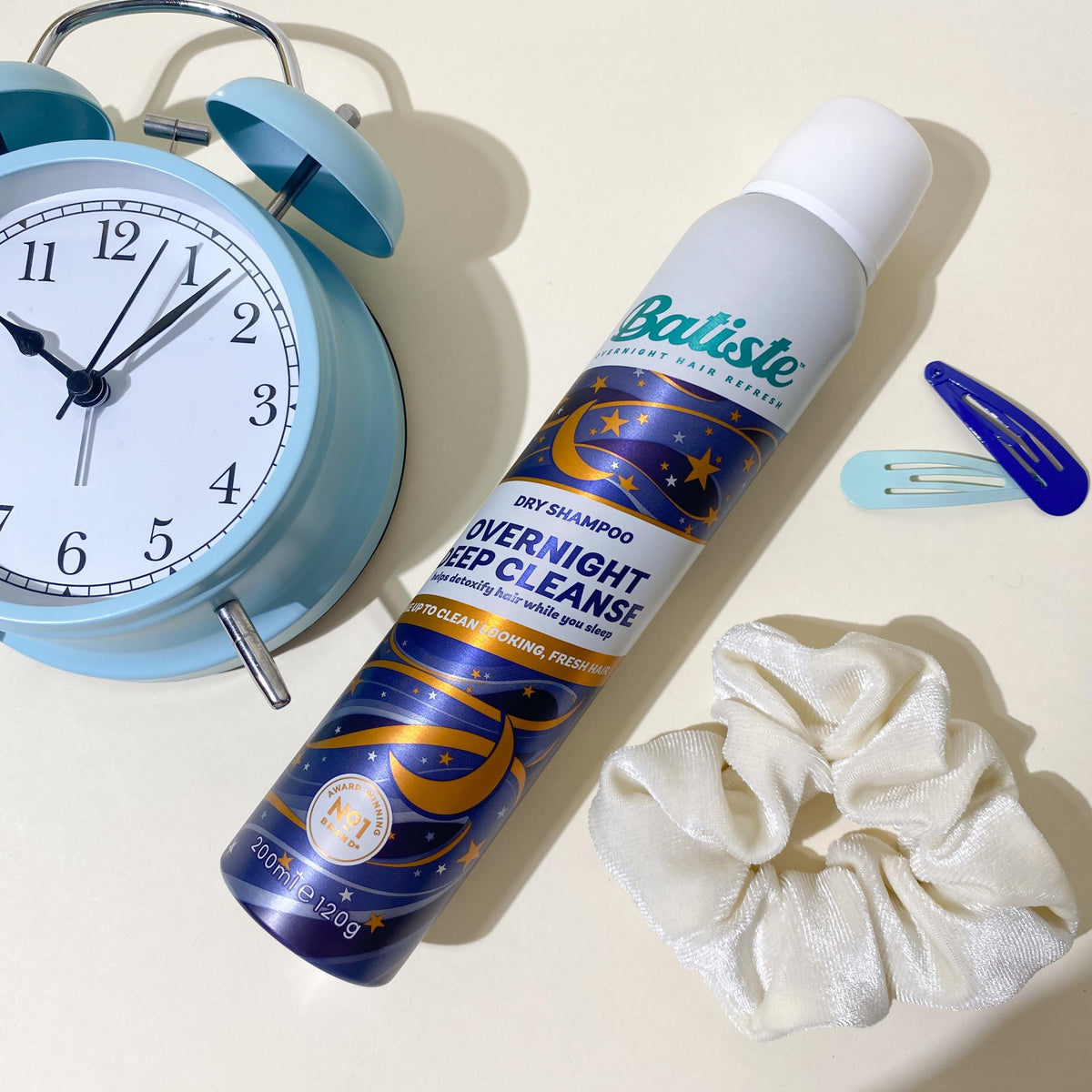 Batiste can held in hand to show 3.81 oz travel-friendly scale