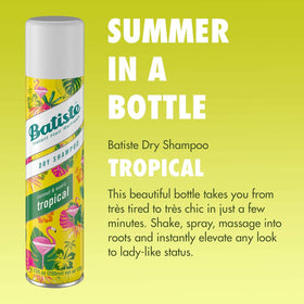 Hand holding a Batiste bottle to show 3.81 oz scale and portability benefit