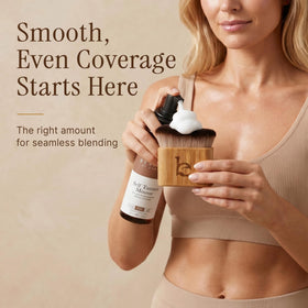 Beauty by Earth brush next to hand showing compact size and easy maneuverability