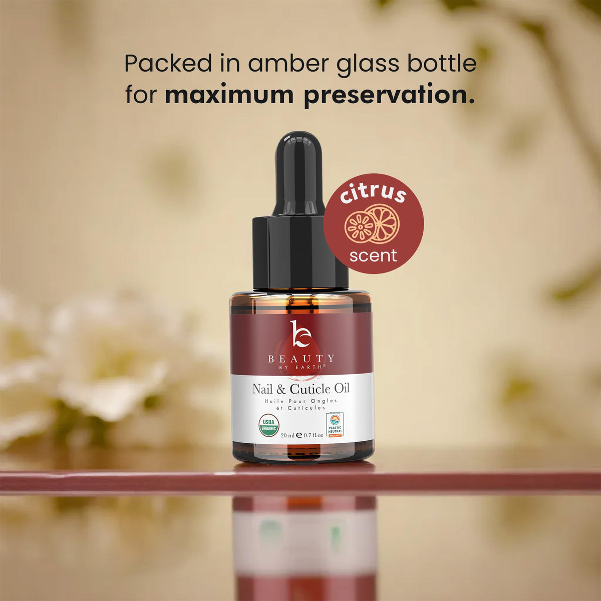 Beauty by Earth bottle beside coin for scale showing compact travel-friendly size