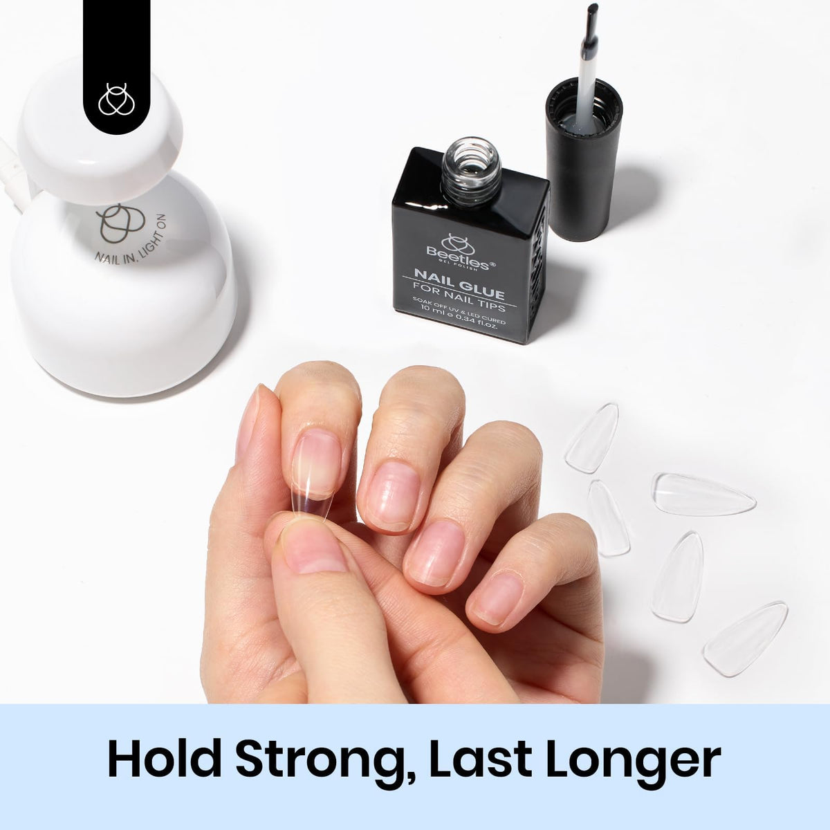 Beetles Gel Polish applied to a tip being cured under LED lamp for fast bonding