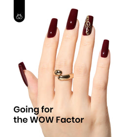 Beetles Gel Polish on manicured hand showing salon-quality burgundy nails benefit