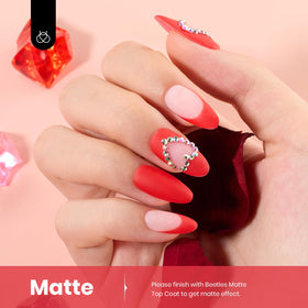 Beetles red gel polish on nail swatch hand showing high gloss shine and salon finish